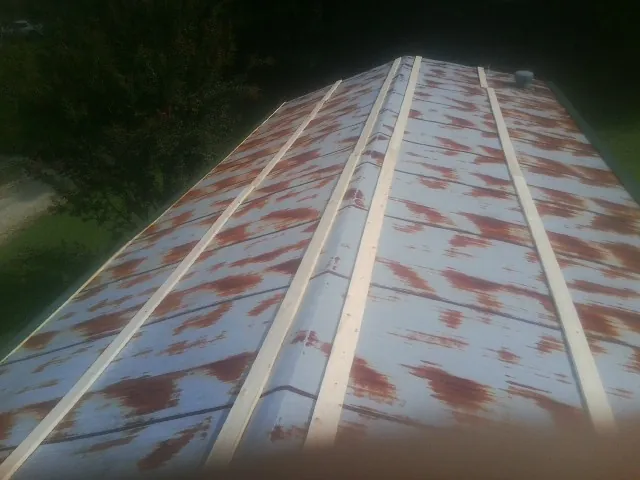 Rusted metal roof panels with new wood purlins before replacement — Storm Damage Roof Repair in Pillsbury by Roofing Brothers